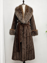 Load image into Gallery viewer, 1970s vintage style dark brown long coat featuring a plush silver-tipped faux fur shawl collar, tiered ruffled texture, matching furry cuffs, and a self-tie belt.