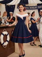 Load image into Gallery viewer, 1950s vintage style navy blue nautical sailor swing dress featuring an off-the-shoulder white collar with red stripe accents.
